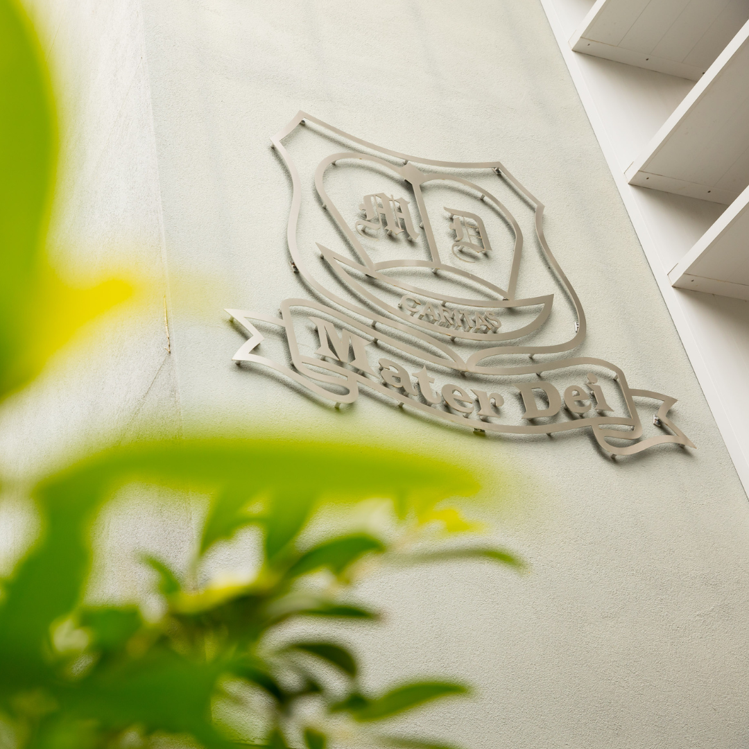 Mater Dei Catholic Primary School signage on a school building, representing school identity and Catholic community presence